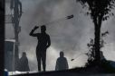 Demonstrators hurl rocks at Israeli troops in the West Bank town of Al-Ram as Palestinians vent their anger over Thursday's deadly raid in Jenin