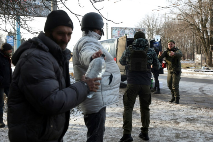 Volunteers unload food and water from a van outside a humanitarian aid and heating point in Bakhmut