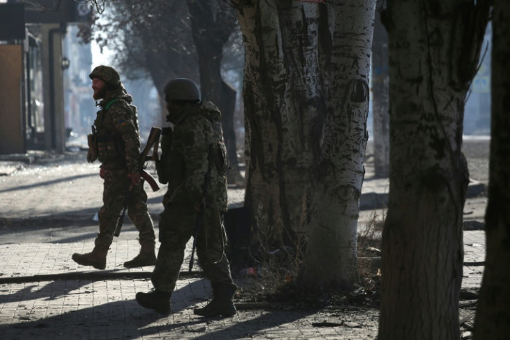 Ukrainian servicemen walk in a street of Bakhmut, the scene of the war's longest-running battle