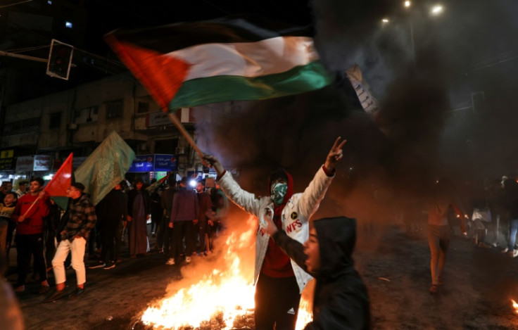 Palestinians celebrate in Gaza City following a shooting attack by a Palestinian gunman outside an east Jerusalem synagogue