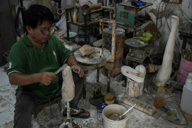 Saga makes prosthetic legs and hands inside his workshop in Tangerang to help people with disabilities have access to artificial limbs at affordable prices