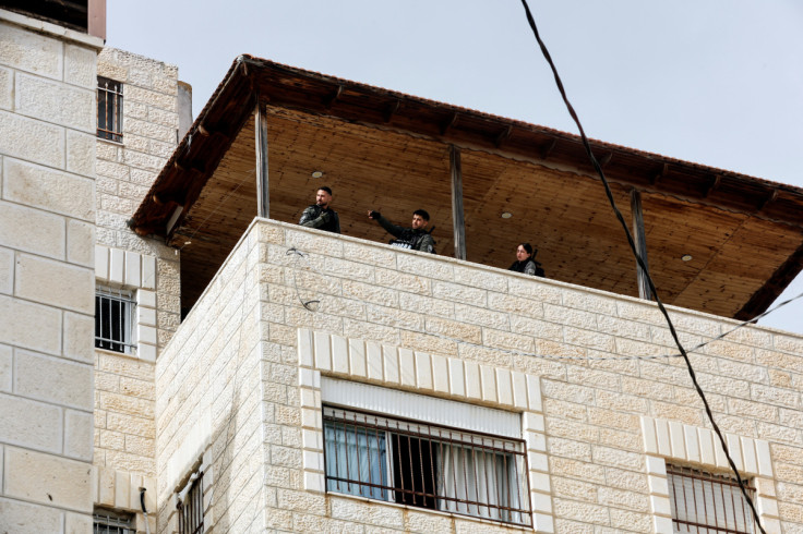 Israeli Border police officers stand at the house of Palestinian gunman Khaire Alkam in A-Tur in East Jerusalem
