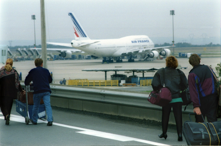 Passengers at Paris's Charles de Gaulle (Roissy) airport pull their baggage along a ramp in front of..