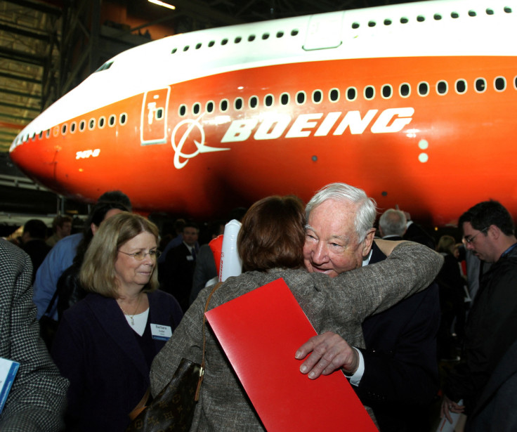 Joe Sutter, Boeing's chief engineer on the original jumbo, hugs a woman in front of a newly unveiled 747-8 jumbo passenger jet in Everett