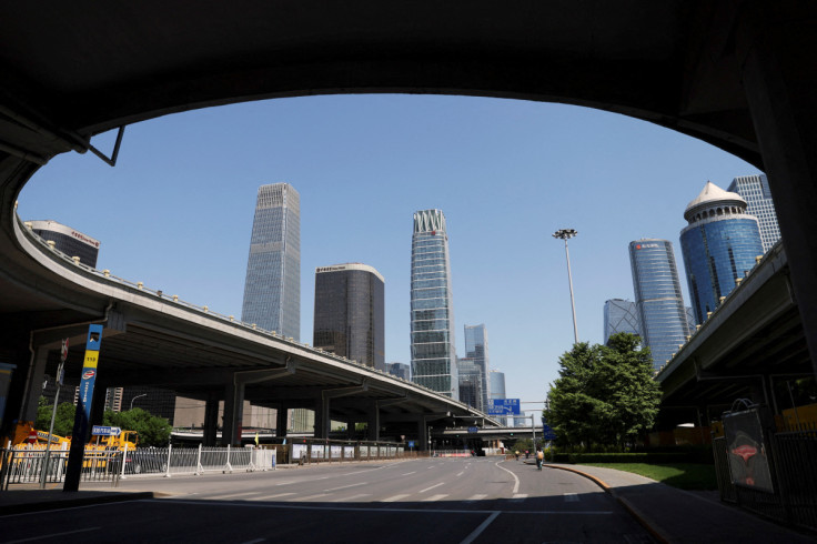 People cycle on a road at the Central Business District (CBD) in Beijing