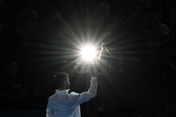 Novak Djokovic poses with the Norman Brookes Challenge Cup after wining his 10th Australian Open and 22nd Grand Slam