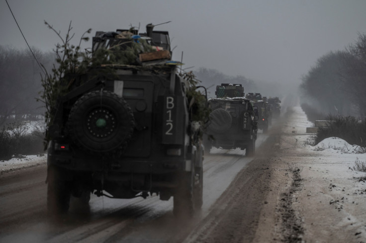 Armoured personnel carriers ride on a road near a frontline in Donetsk region