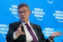Bourla, CEO of Pfizer gestures  during a discussion at the World Economic Forum in Davos