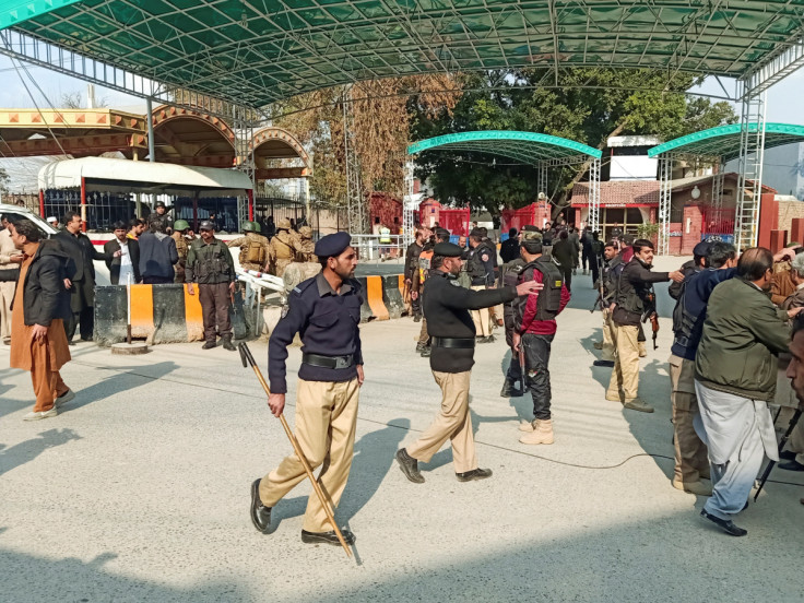 Police officers control the crowd after a suicide blast in a mosque, at police line area in Peshawar