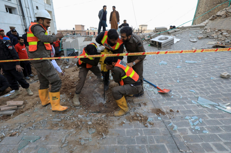 Rescue workers drill a portion of a collapsed roof, after a suicide blast in a mosque in Peshawar