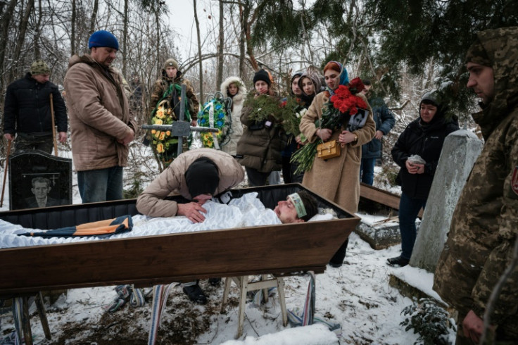 Natalia Shalashnaya (C), 52, mourns over the casket of a Ukrainian serviceman of the Azov battalion killed in action in Bakhmut, 28-year-old Oleksandr Korovniy