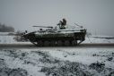 A Ukrainian BMP-2 infantry combat vehicle drives down an icy road in the Donetsk region, where Ukrainian and Russian forces are in a tough fight over several key frontline towns