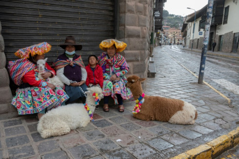 Indigenous women in Cusco wait in the street for the arrival of tourists in the hope of being able to make some money