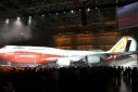 Boeing raises a curtain to unveil the 747-8 jumbo passenger jet to thousands of employees and guests at the company's Everett, Washington commercial airplane manufacturing facility