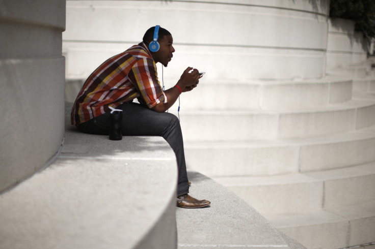 A man with Beats headphones listens to music on an iPhone in Los Angeles