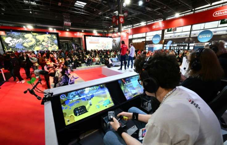 Participants attend a video game competition at the Nintendo booth on the opening day of the 'Paris Games Week' video game fair