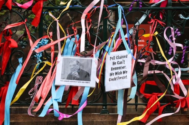 Ribbons and banners placed by protesters hang from the fence surrounding St. Mary's Cathedral, where the body of Catholic Cardinal George Pell lies in state in Sydney on February 1, 2023.