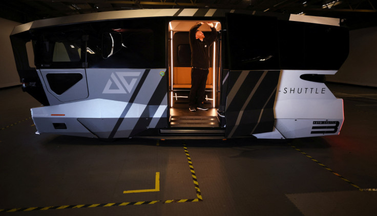 A worker adjusts the roof lights inside an autonomous ‘Auto-Shuttle’ vehicle inside the Aurrigo factory in Coventry