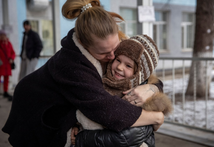 A mother Halyna hugs her daughter Arina after her evacuation from front line city of Bakhmut in Sloviansk