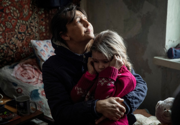 A grandmother hugs her granddaughter Arina before evacuation from front line city of Bakhmut