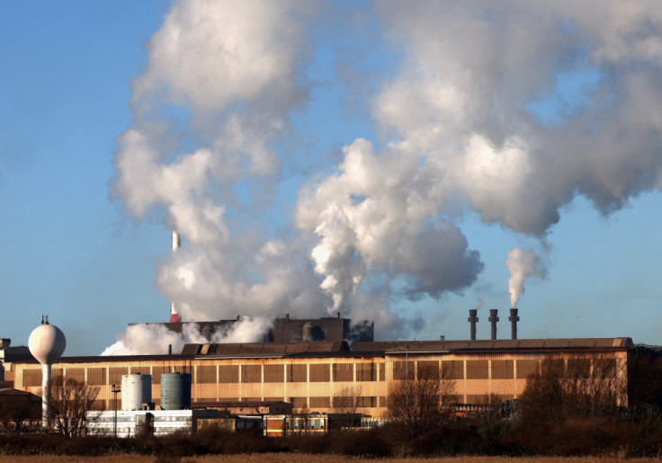 Smoke rises from chimneys at a factory in the port of Dunkirk