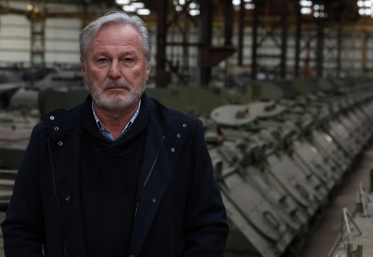 Freddy Versluys, the CEO of Belgian defence company OIP Land Systems, looks on near armoured vehicles, in a hangar in Tournais