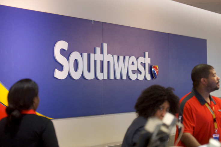 A Southwest Arlines logo is seen as employees check in travelers at the Philadelphia International Airport