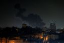 Smoke rises above buildings in Gaza City as Israel launched air strikes on the Palestinian enclave early Thursday