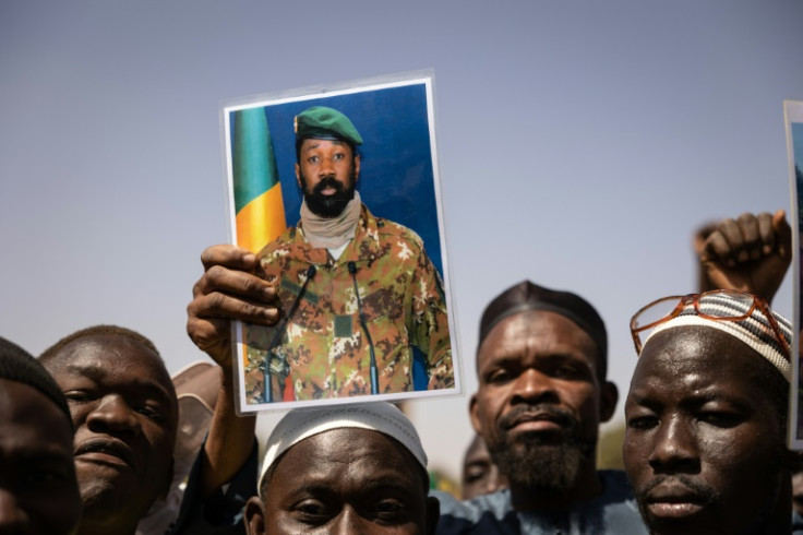Support: Demonstrators at a rally in the Burkinabe capital of Ouagadougou in January 2022 hold up a picture of Malian junta leader Colonel Aissimi Goita