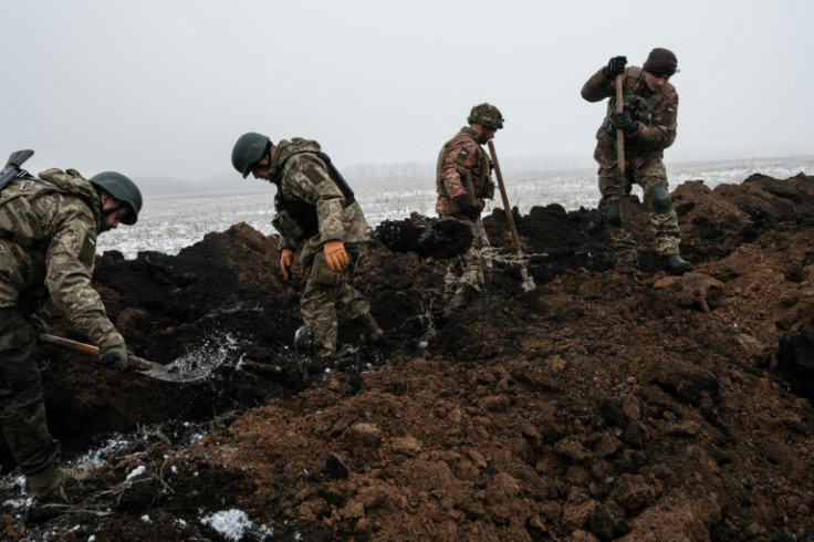 Ukrainian servicemen dig a trench near Bakhmut in the Donetsk region