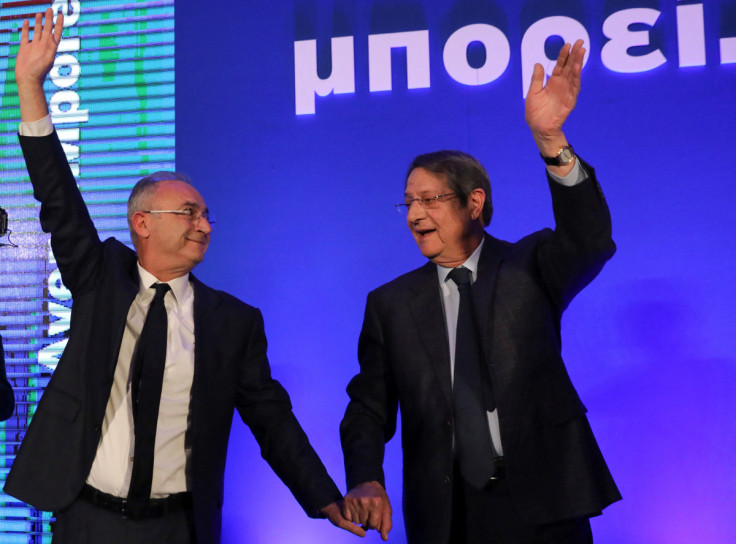 Cyprus' President Nicos Anastasiades and Cyprus presidential candidate Averof Neophytou, head of the governing right-wing Democratic Rally party, waves to supporters during a pre-election rally in Nicosia