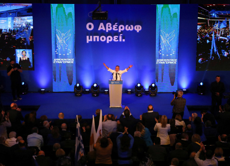 Cyprus presidential candidate Averof Neophytou, head of the governing right-wing Democratic Rally party, waves to supporters during a pre-election rally in Nicosia