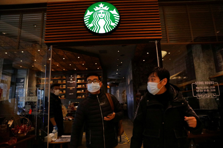 People leave a Starbucks flagship store in Beijing