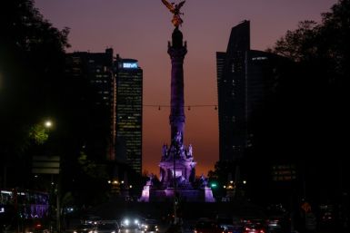 The sun sets behind the Angel of Independence monument in Mexico City