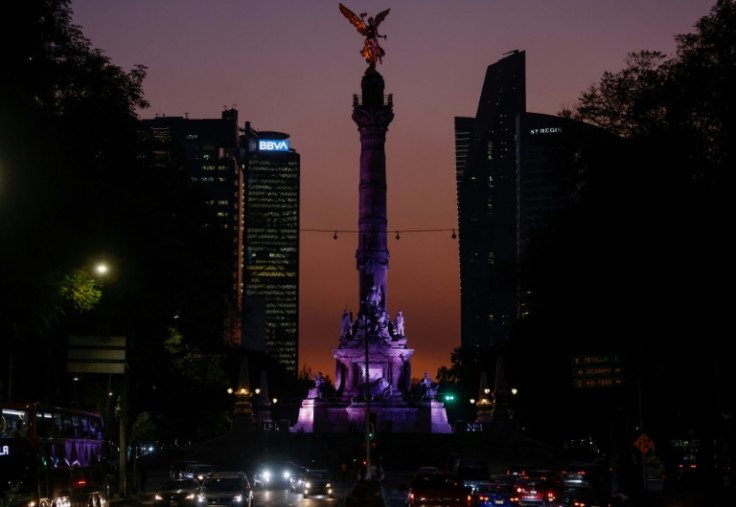 The sun sets behind the Angel of Independence monument in Mexico City