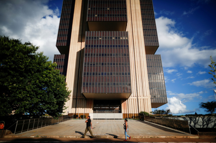 People walk in front the Central Bank headquarters building in Brasilia