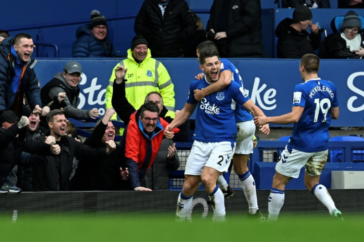 Everton defender James Tarkowski (C) celebrates scoring against Arsenal