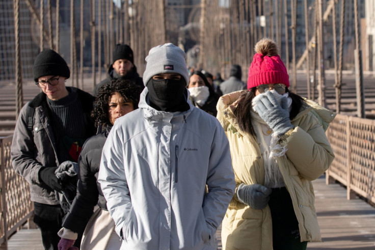 People walk during cold temperature and high winds in Manhattan, as deep cold spread across the northeast United States in New York City