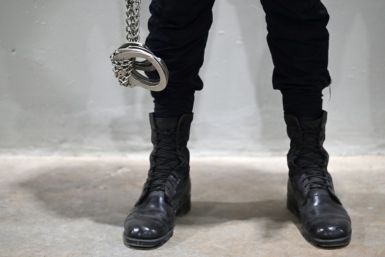 A security guard carrying shackles at the sprawling new prison in Tecoluca, El Salvador