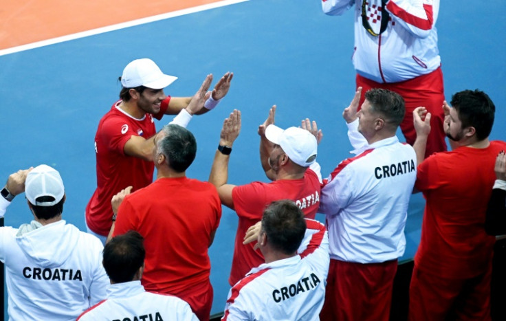 Team effort: Borna Coric celebrates with his Croatia teammates after defeating Austria's Dominic Thiem