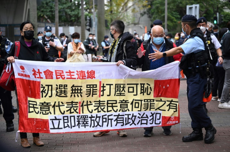 A rare, small protest erupted outside the court where Hong Kong's largest national security trial began