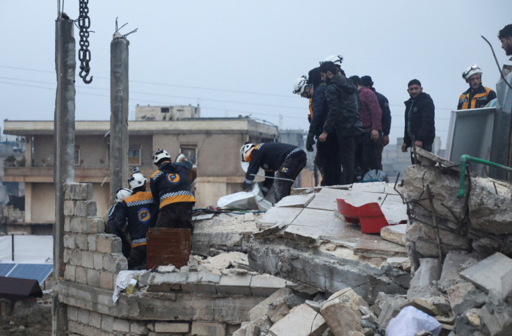 Rescuers search for survivors, following an earthquake, in rebel-held Azaz