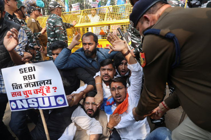 Members of National Students' Union of India (NSUI) react as they are being detained by police during a protest demanding a probe by a Joint Parliamentary Committee (JPC) into Adani Group, in New Dehli
