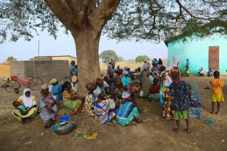 Burkinabe refugees gather under a tree at a settlement in Bawku, northern Ghana, where they fled after their hamlet was attacked across the border