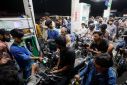People wait to get fuel at a petrol station, in Karachi