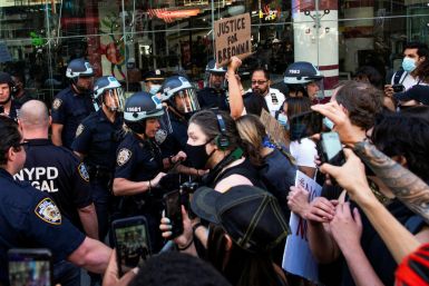Demonstrators scuffle with NYPD police officers as they try to march trough Times Square during a protest against racial inequality in the aftermath of the death in Minneapolis police custody of George Floyd, in New York City, New York