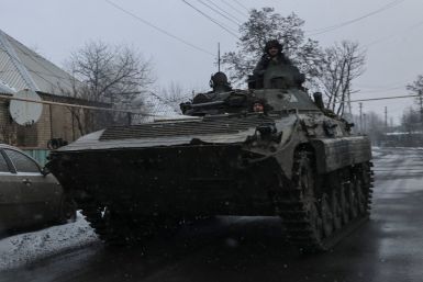 Ukrainian service members ride a BMP-1 infantry fighting vehicle near the frontline town of Bakmut