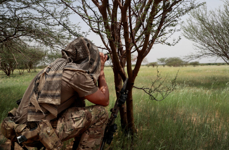 A soldier from the new Takuba force keeps watch during a patrol with Malian soldiers near Niger border in Dansongo Circle