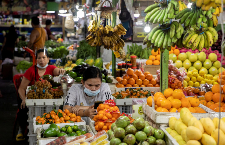 Vendors wearing face masks for protection against the coronavirus disease (COVID-19) stand by their fruit stalls at a public market in Quezon City, Metro Manila