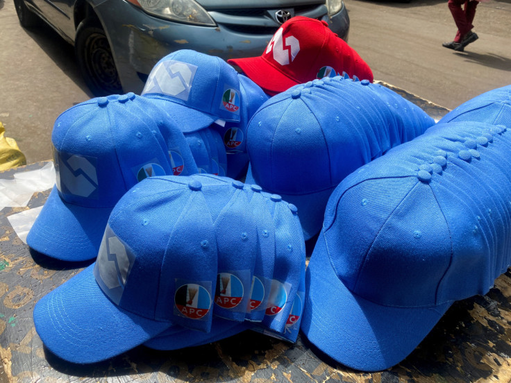 Branded baseball caps with the logo of All Progressives Congress (APC) are displayed at a shopping center in Abuja